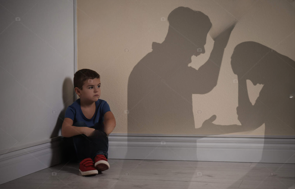 A toddler watching two adults arguing.